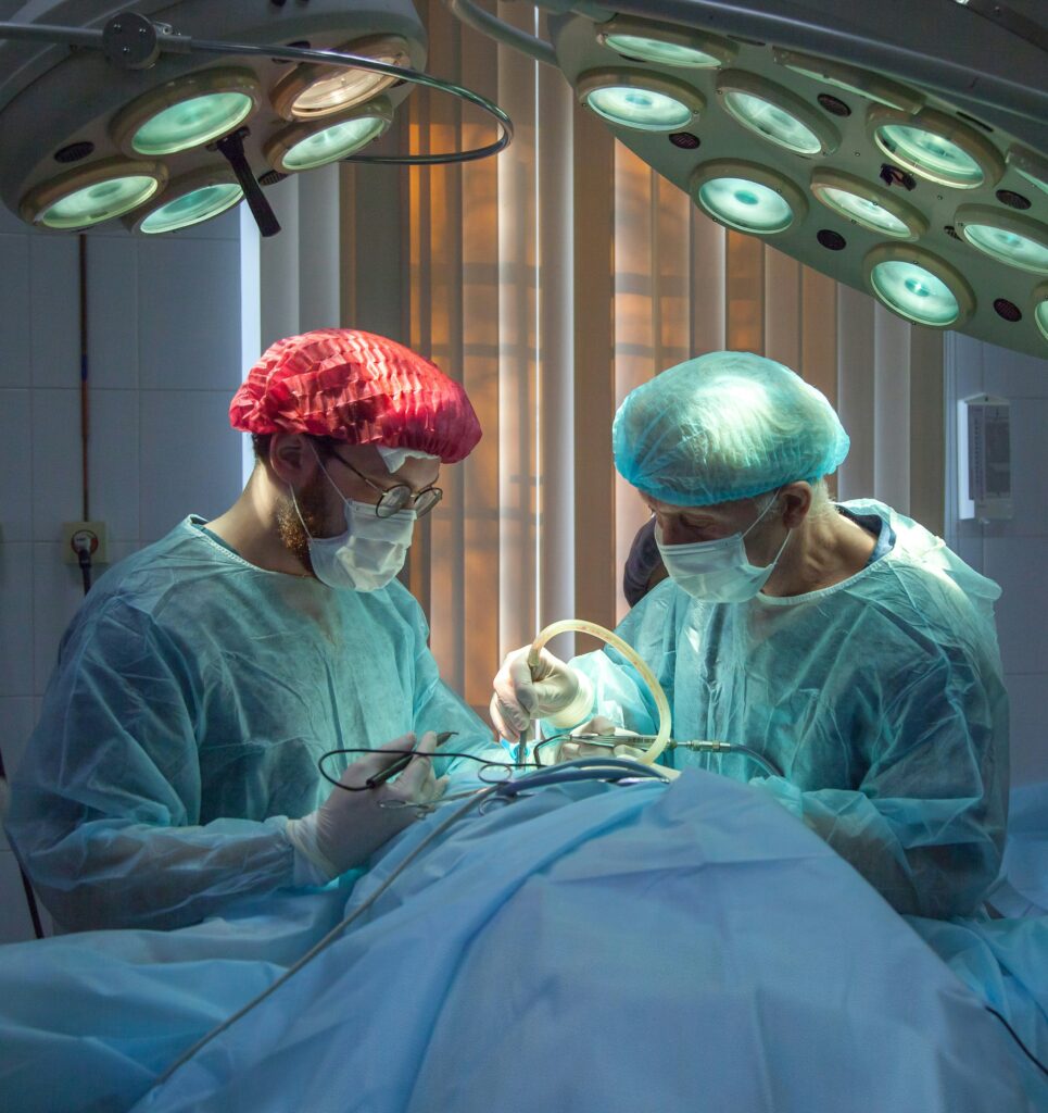 Two surgeons in a room with lights on